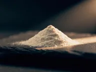 Fine white powder on dark slate.