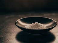 Fine powder in a black dish.