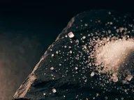 Crystalline granules on dark stone.